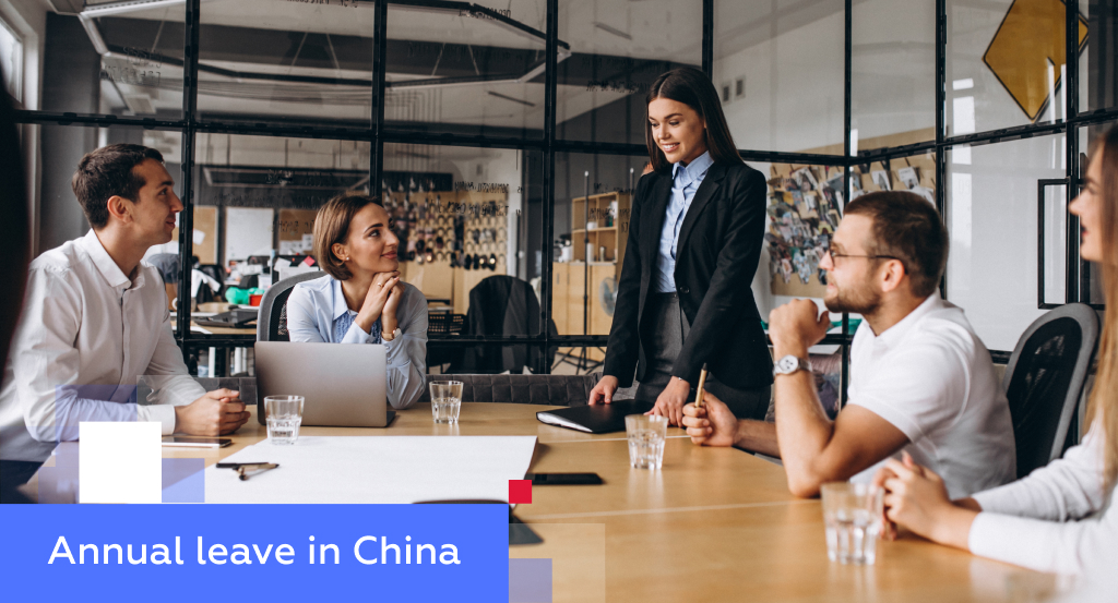 Team meeting with a presenter in a glass-walled conference room — illustrating annual leave in China