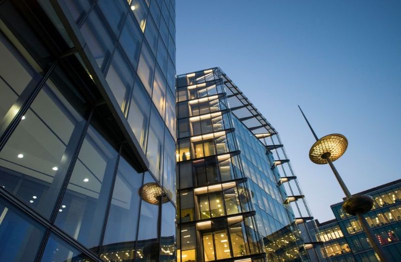 Modern glass corporate office building lit at twilight — illustrating MSA Asia’s review of FDI China