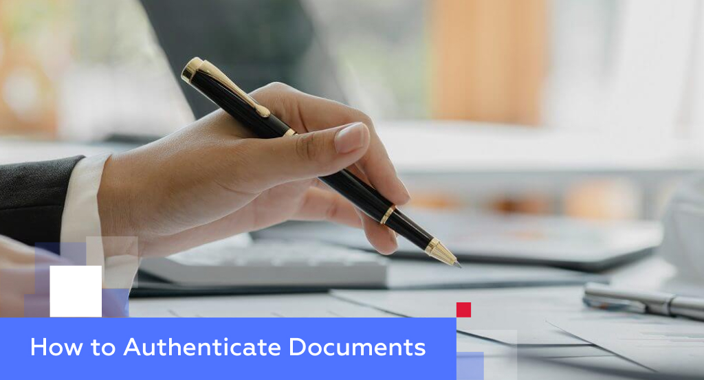 Hand holding a fountain pen above signed documents — illustrating how to authenticate documents for China