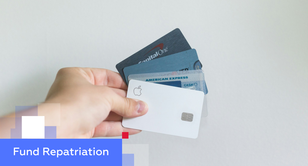 Hand holding a fan of credit cards — illustrating how to repatriate funds from China