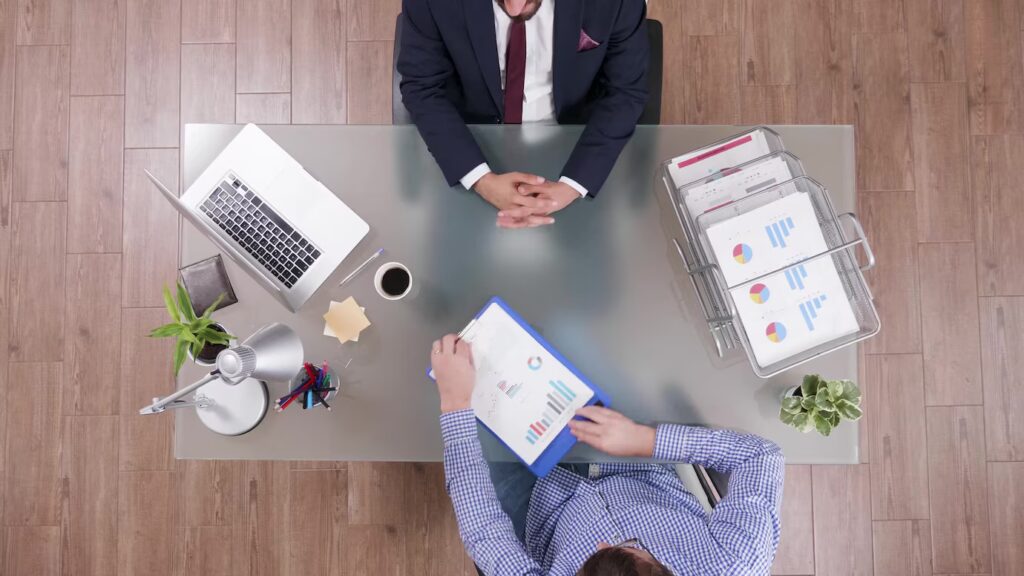 Top-down view of two professionals reviewing charts and a tablet at a desk — illustrating MSA Asia’s incorporation services in China