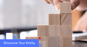 Hand stacking wooden cubes into a staircase shape — illustrating how to structure your entity in China