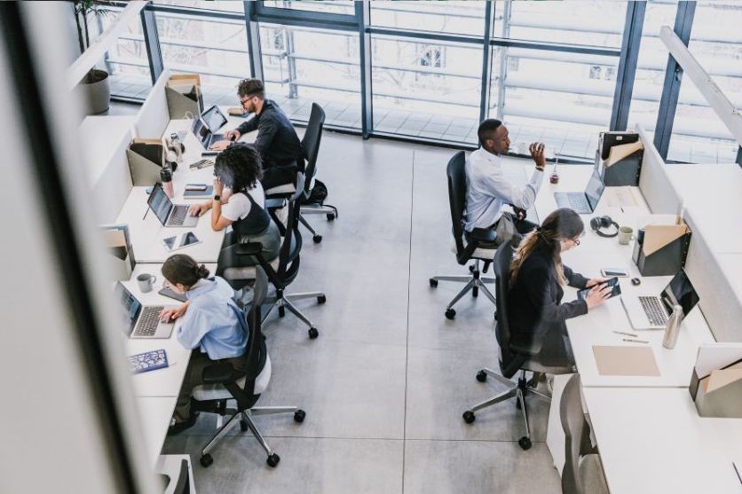 Open-plan office with diverse professionals at sleek desks viewed from above — illustrating MSA Asia’s review of Vistra